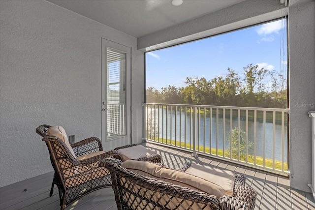 sunroom / solarium with a water view