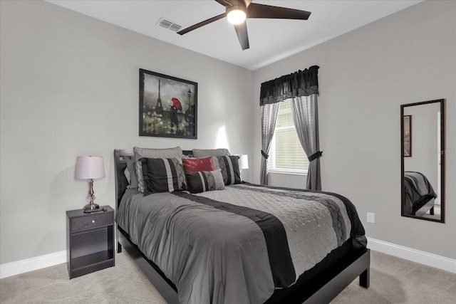 bedroom with ceiling fan and light carpet