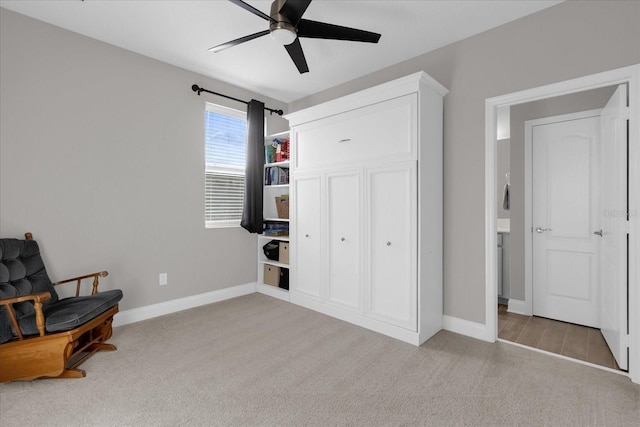 sitting room featuring light carpet and ceiling fan