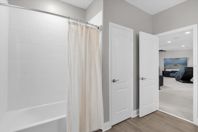 bathroom featuring shower / bathtub combination with curtain and wood-type flooring