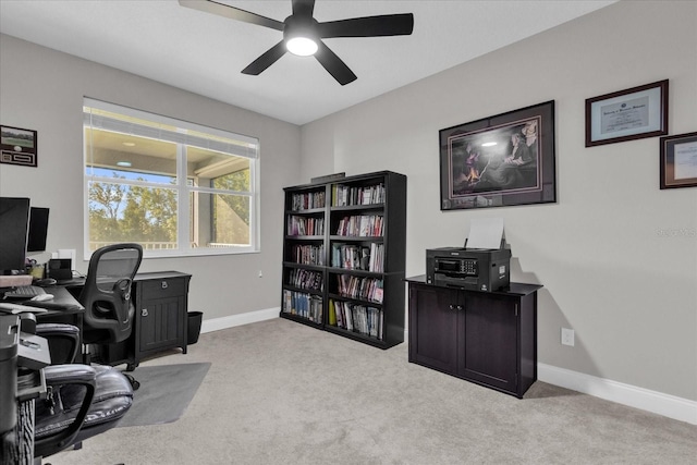 office space with light colored carpet and ceiling fan