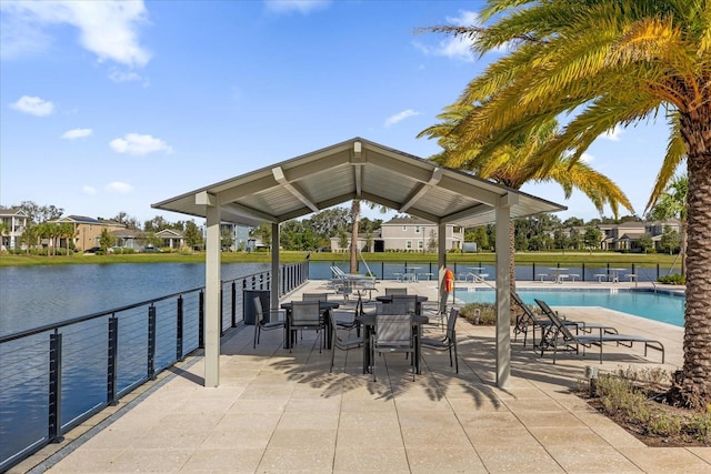 view of patio / terrace with a community pool and a water view