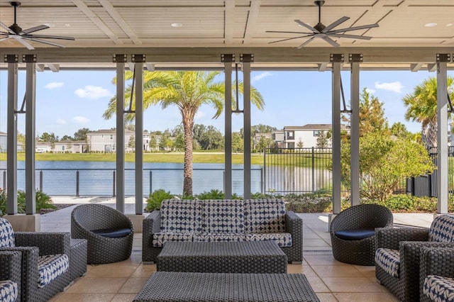 sunroom / solarium featuring wooden ceiling, a water view, and ceiling fan