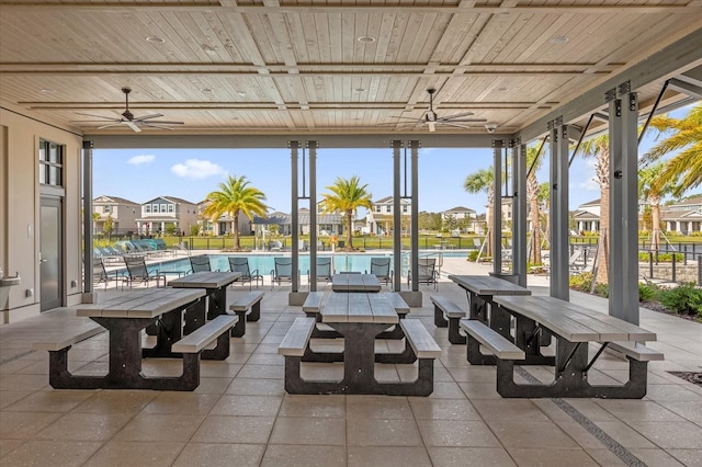 view of patio featuring a community pool and ceiling fan