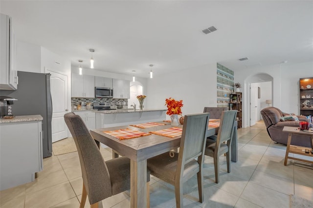 tiled dining area featuring sink