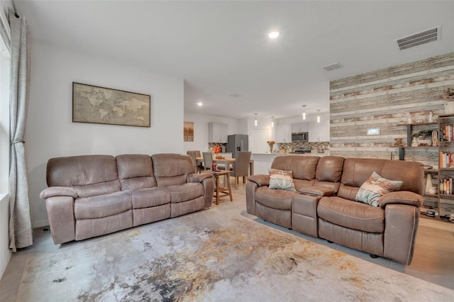 living room with wood walls