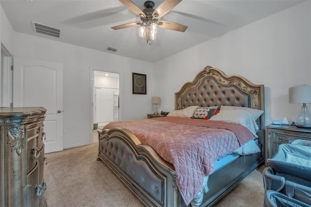 carpeted bedroom with connected bathroom and ceiling fan