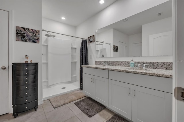 bathroom with tile patterned floors, curtained shower, and vanity