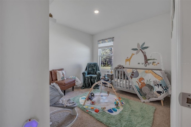 bedroom featuring carpet flooring and a crib