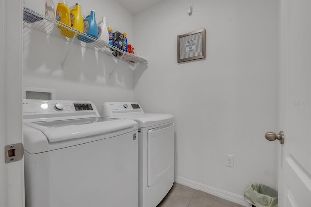 laundry area with light tile patterned floors and independent washer and dryer