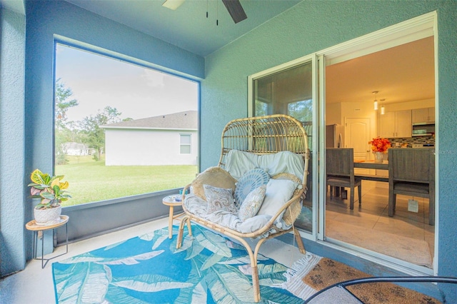 sunroom / solarium featuring ceiling fan