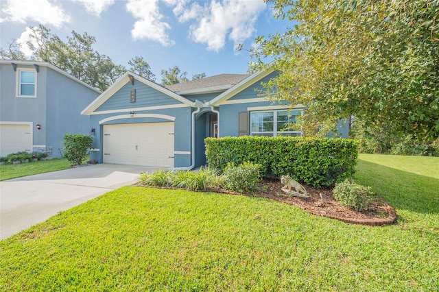 view of front of house featuring a front yard and a garage