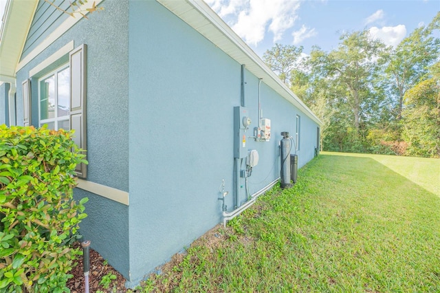 view of side of home featuring a yard