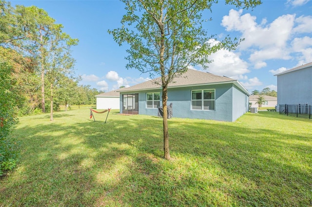 rear view of house with a yard