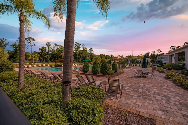 patio terrace at dusk with a community pool