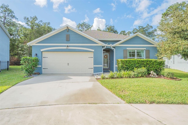 single story home featuring a garage and a front lawn