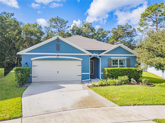 view of front of house featuring a front lawn and a garage