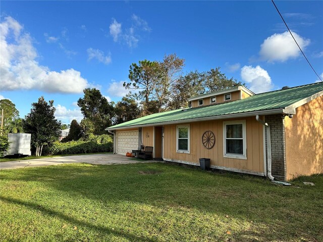 view of front of property with a front yard and a garage