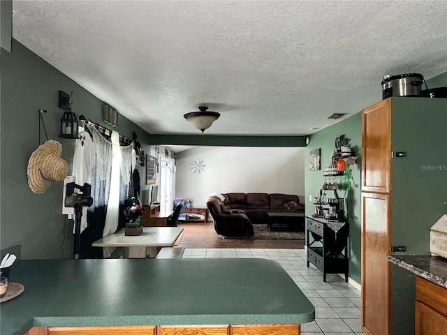 kitchen featuring a textured ceiling and light tile patterned floors