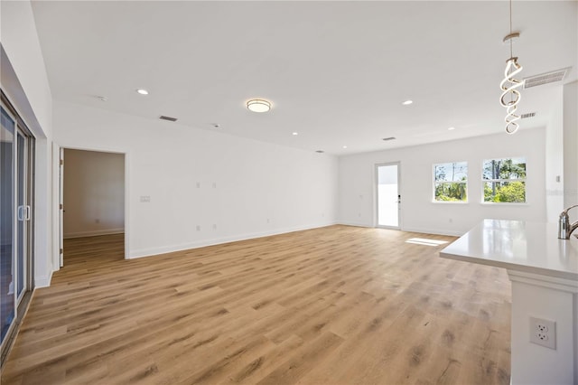 unfurnished living room with light wood-type flooring