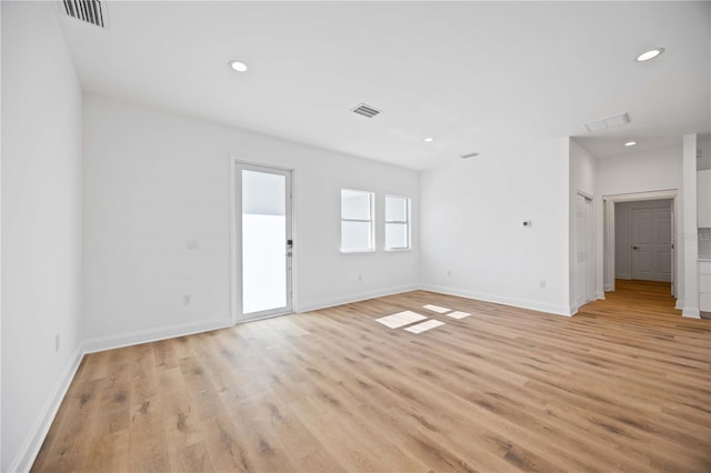 spare room featuring light hardwood / wood-style floors