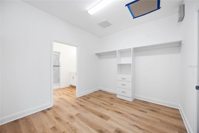 spacious closet with light hardwood / wood-style flooring