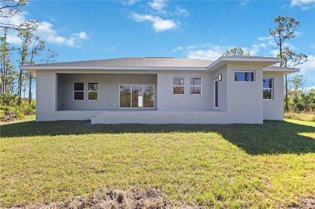 rear view of house with a lawn