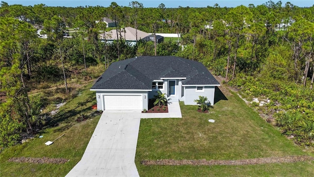 view of front of home with a front yard and a garage