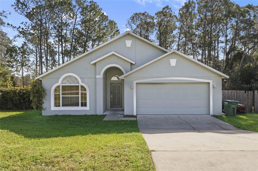 ranch-style home featuring a front lawn and a garage