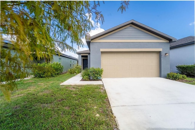 view of front of property featuring a front yard and a garage