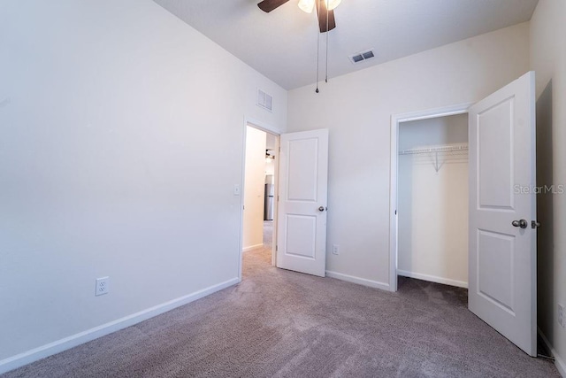 unfurnished bedroom featuring a closet, ceiling fan, and carpet