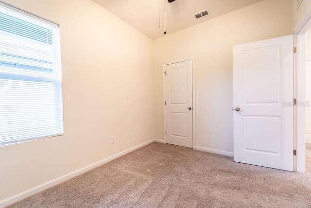 spare room with light colored carpet