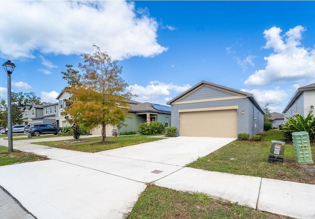 view of front of home featuring a front lawn and a garage