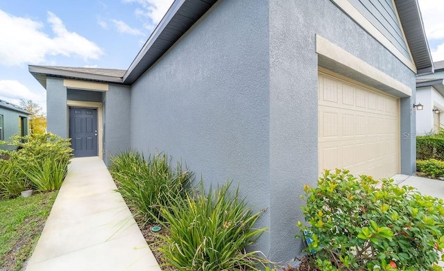 view of exterior entry with a garage