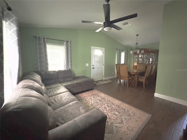 living room with ceiling fan, lofted ceiling, and dark hardwood / wood-style floors