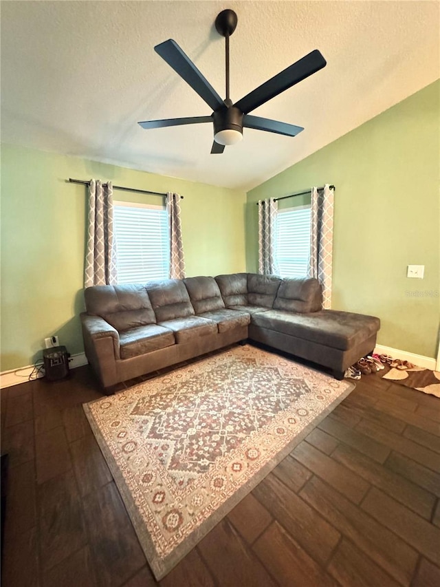 living room featuring hardwood / wood-style floors, a textured ceiling, vaulted ceiling, and ceiling fan