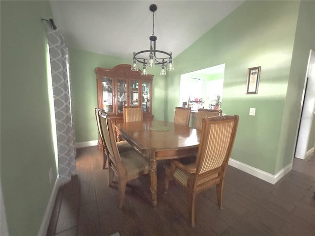 dining space featuring lofted ceiling, a notable chandelier, and dark wood-type flooring