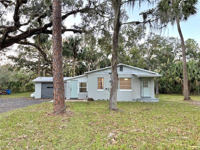 ranch-style home with a front lawn and a garage