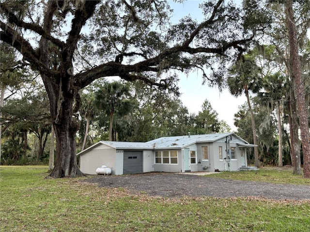 view of front of house with a front yard and a garage