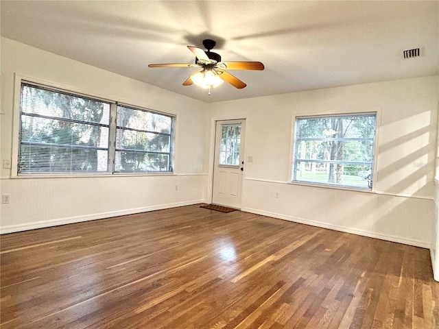 spare room featuring dark wood-type flooring and ceiling fan