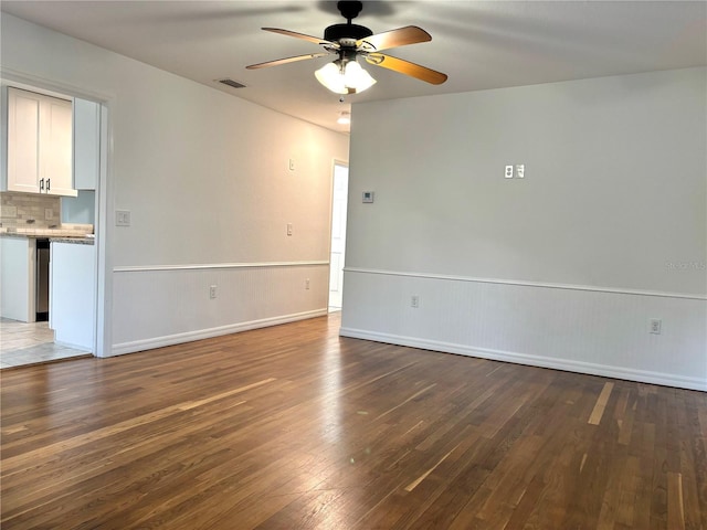 unfurnished room featuring dark hardwood / wood-style floors and ceiling fan