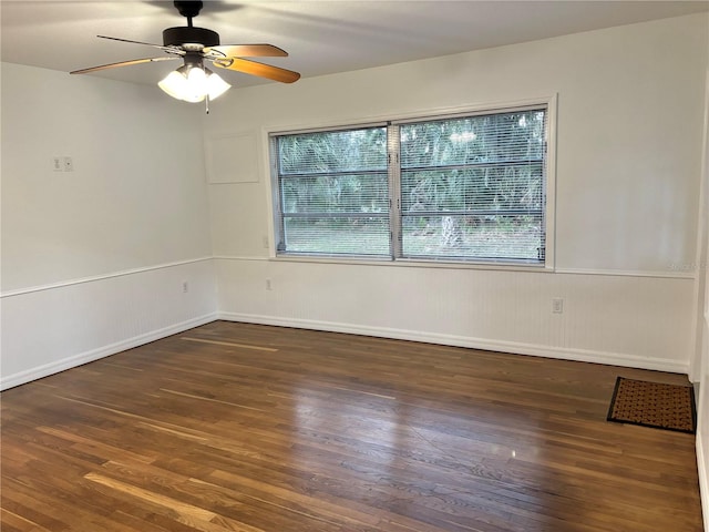 empty room featuring ceiling fan and dark hardwood / wood-style flooring