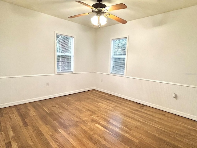 spare room featuring hardwood / wood-style floors and ceiling fan