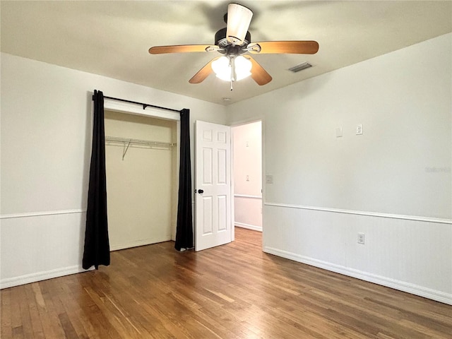 unfurnished bedroom with a closet, ceiling fan, and hardwood / wood-style flooring