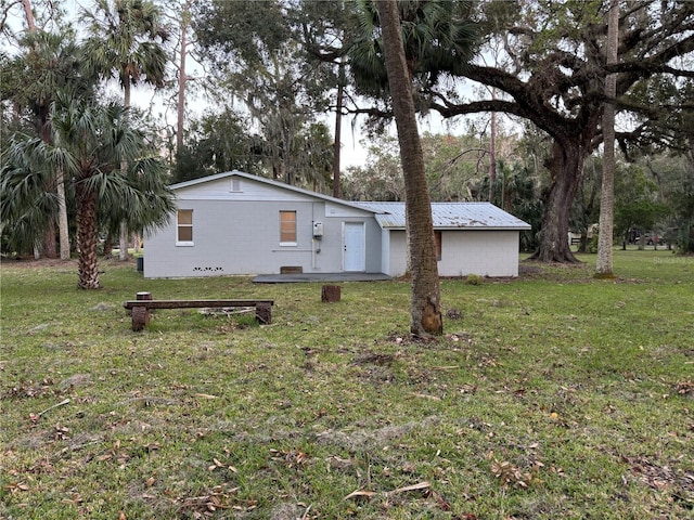 view of property exterior with a lawn