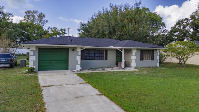 ranch-style house with a garage, a front lawn, and central air condition unit