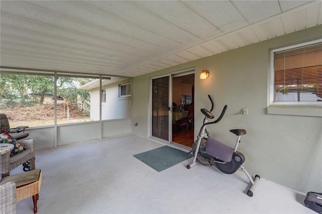 exercise area featuring a healthy amount of sunlight and concrete flooring