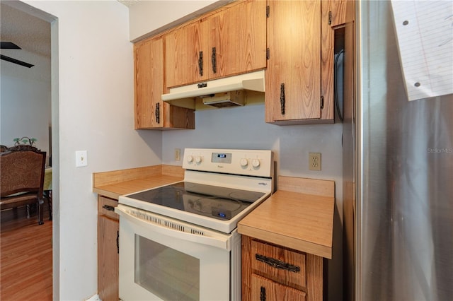 kitchen with white electric range oven and light hardwood / wood-style flooring