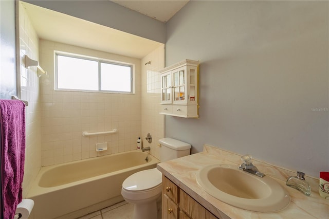 full bathroom with vanity, tiled shower / bath combo, toilet, and tile patterned flooring