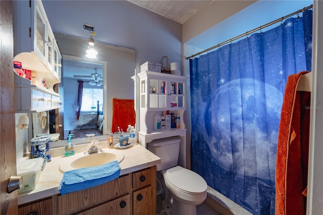 bathroom featuring a textured ceiling, toilet, ceiling fan, walk in shower, and vanity